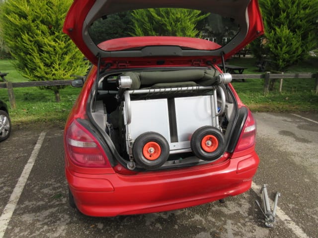 Carp Fishing Trolley being loaded into the rear of a car